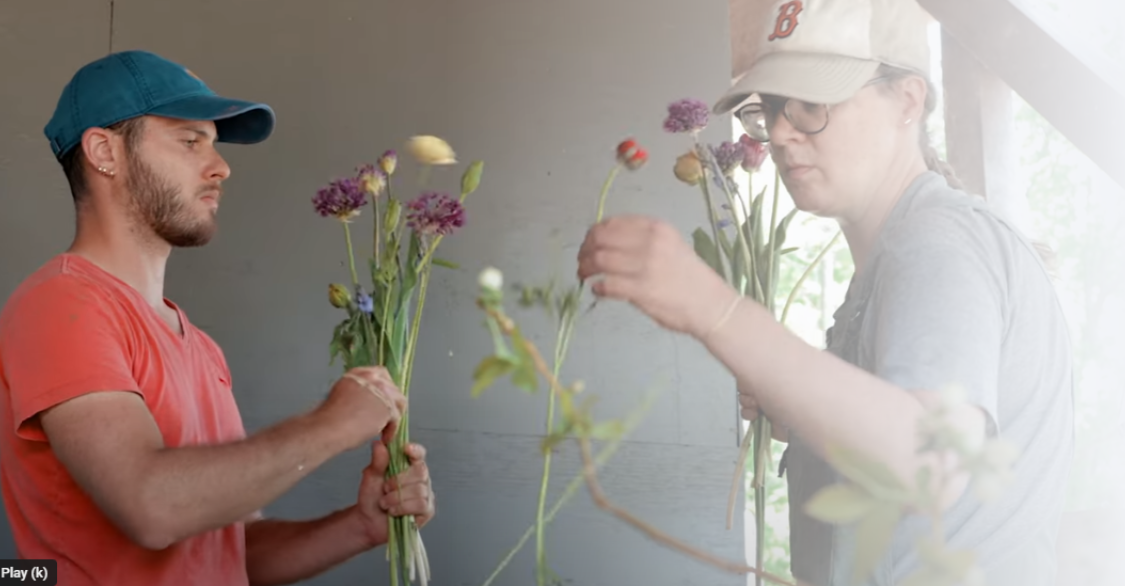 man and a woman arranging bouquets of flowers
